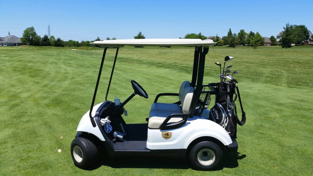 golf cart on golf course grass