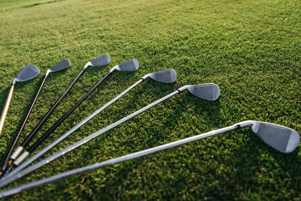 golf clubs lying on grass