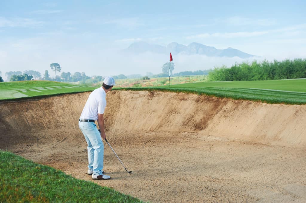 golf shot from sand bunker golfer hitting ball from hazard