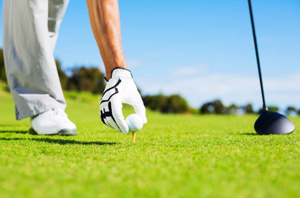 Golfer Placing Golf Ball on the Tee