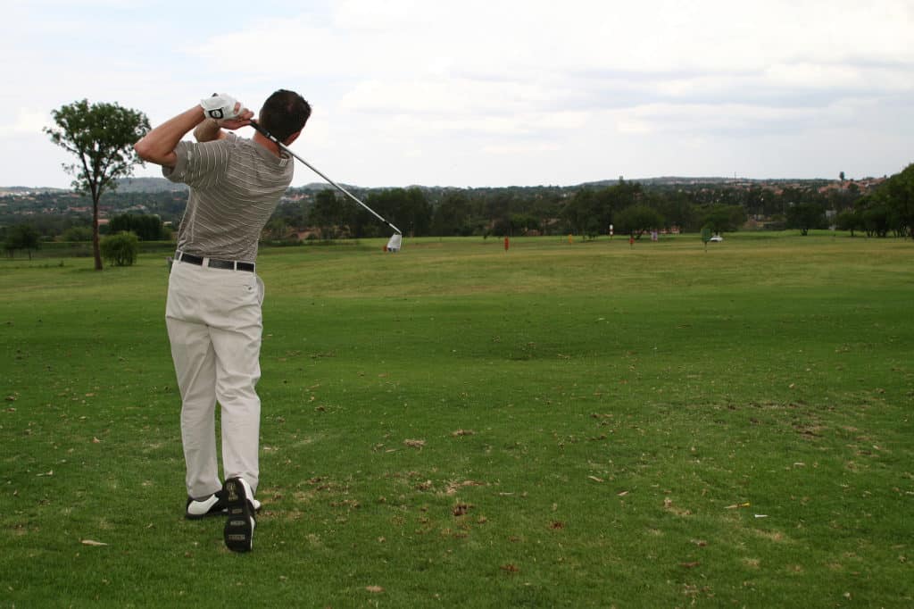 Player hitting a golf ball down the fairway