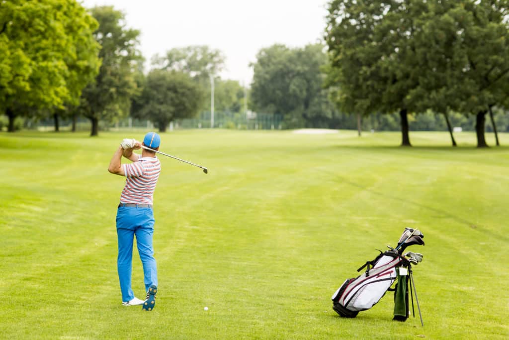 Young man playing golf on the golf course