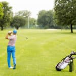 Young man playing golf on the golf course