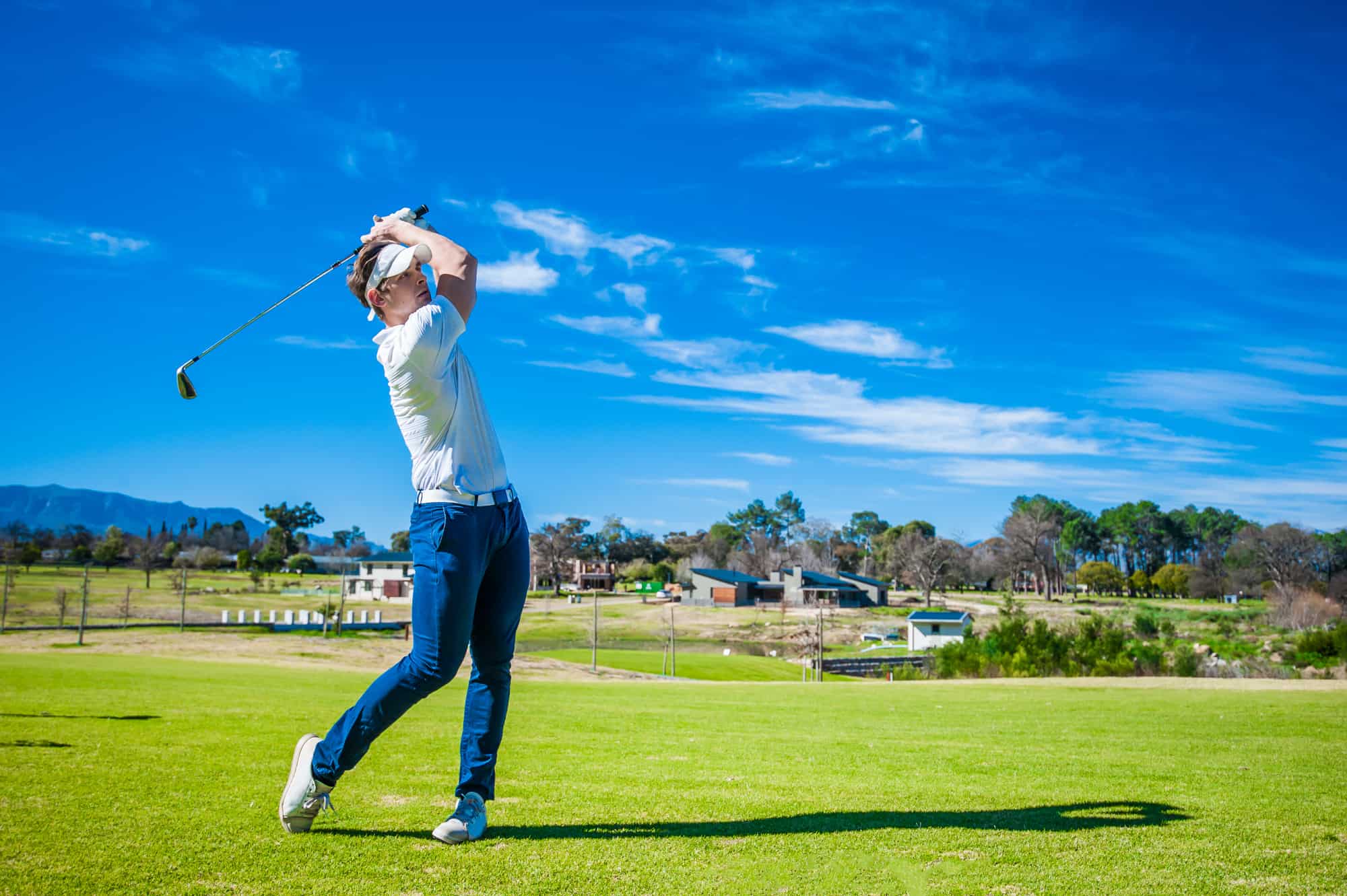 Close up image of a male golfer playing a shot on the fairway on a golf course in south africa