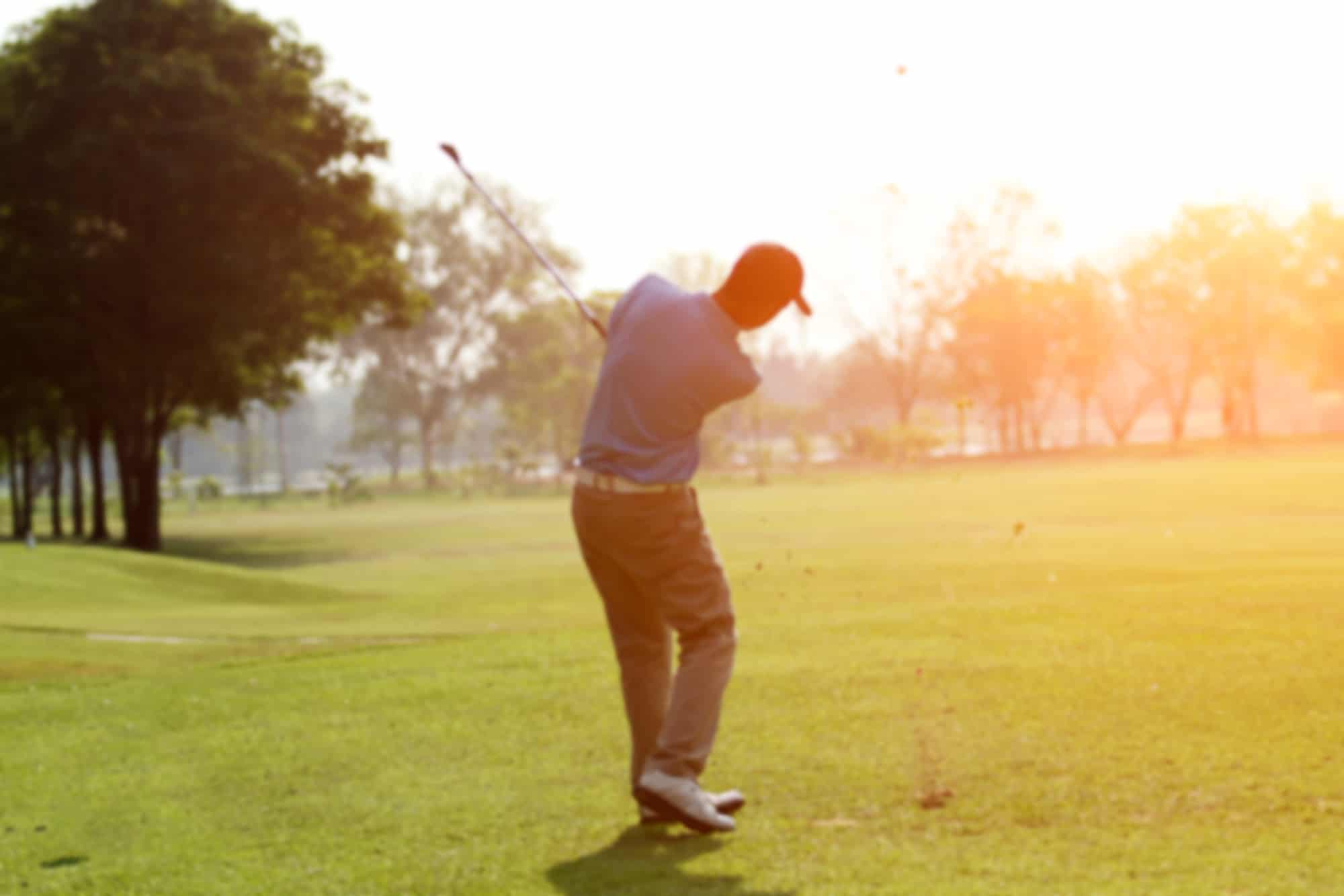 blurred golfers hit sweeping and keep golf course in the summer for relax time