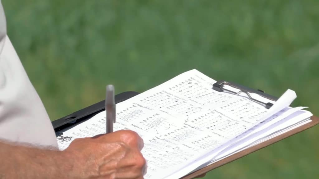 Golfer keeping score on scorecard