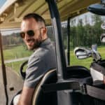 man sitting in golf cart