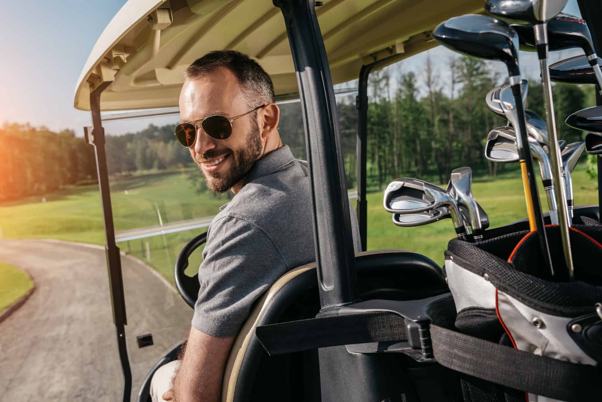 man sitting in golf cart