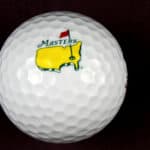 The Masters Tournament logo on a golf ball with black background