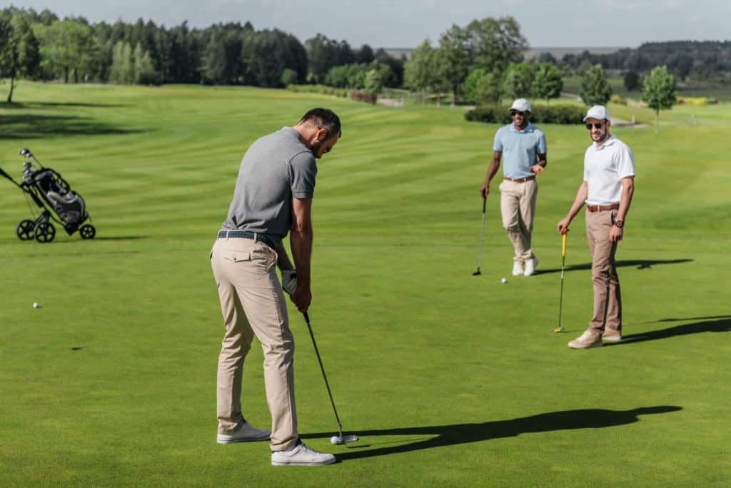 people golfing on green