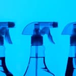 Three spray bottles on blue back ground looking like an x-ray
