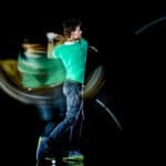 Golfer man golfing golf swing isolated black background multiple exposure
