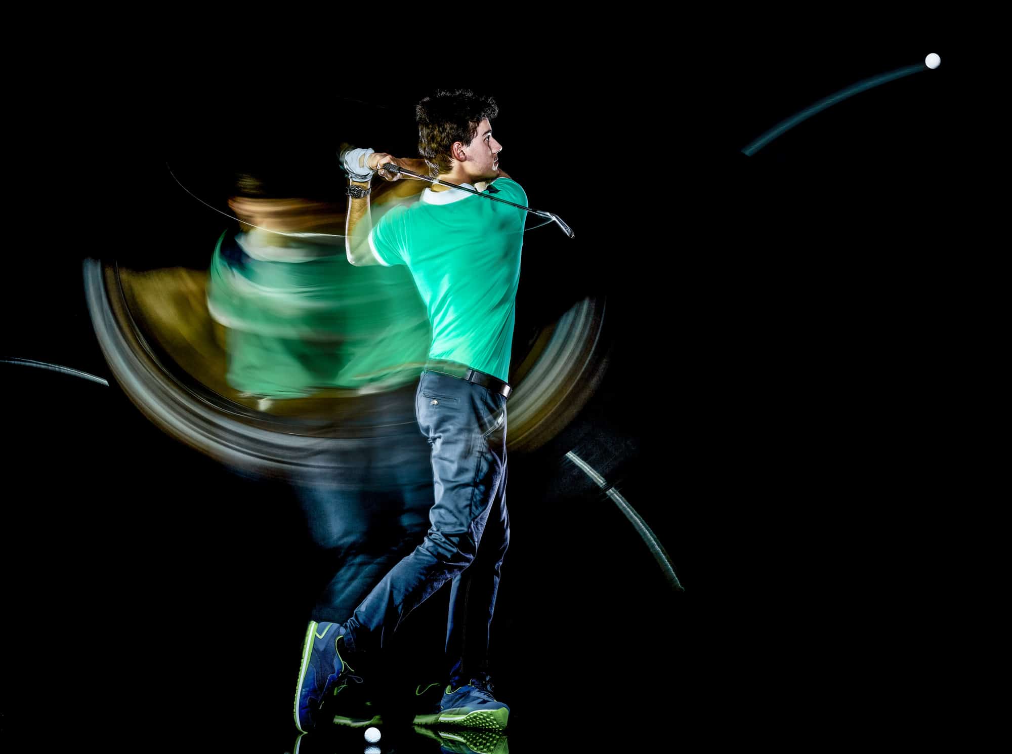 Golfer man golfing golf swing isolated black background multiple exposure