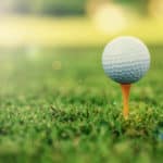 Golf ball standing on tee