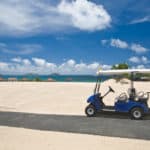 Golf cart on a beach with blue sky