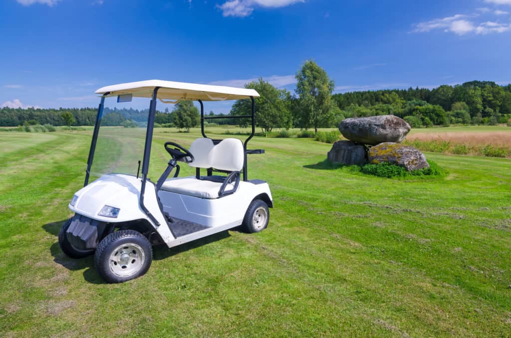 golf cart parked on grass