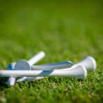 White golf tees on the grass