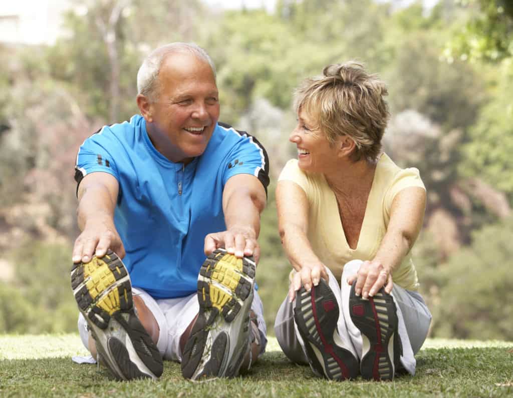 Senior Couple Exercising In Park