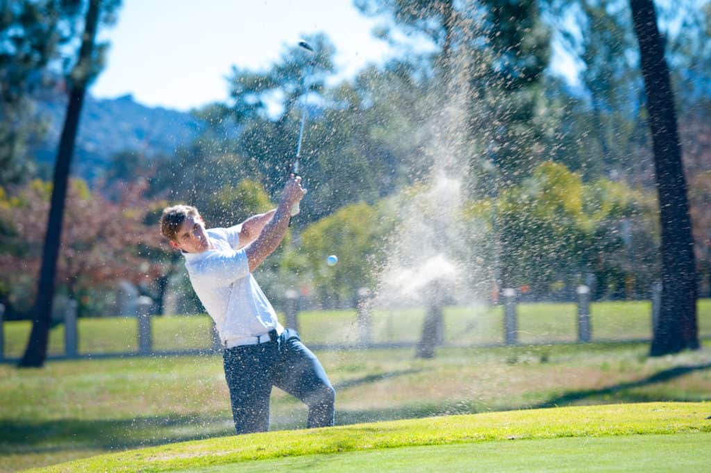 golfer playing a chip shot onto the green