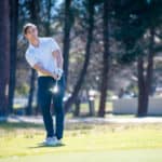 image of a golfer playing a chip shot onto the green on a golf course in south africa