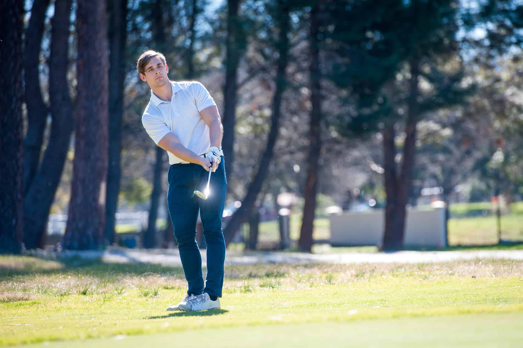 image of a golfer playing a chip shot onto the green on a golf course in south africa