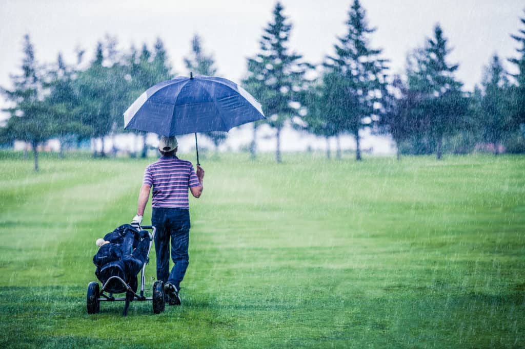 Golfer on a Rainy Day Leaving the Golf Course