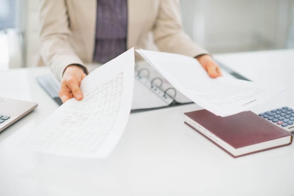 Closeup on clueless business woman with documents