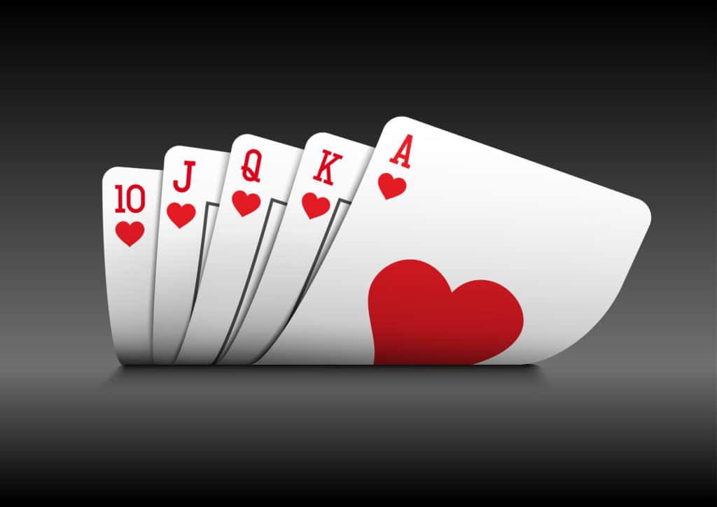 Royal flush playing cards poker hand on black background.