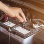 Auto mechanic working check system water and battery