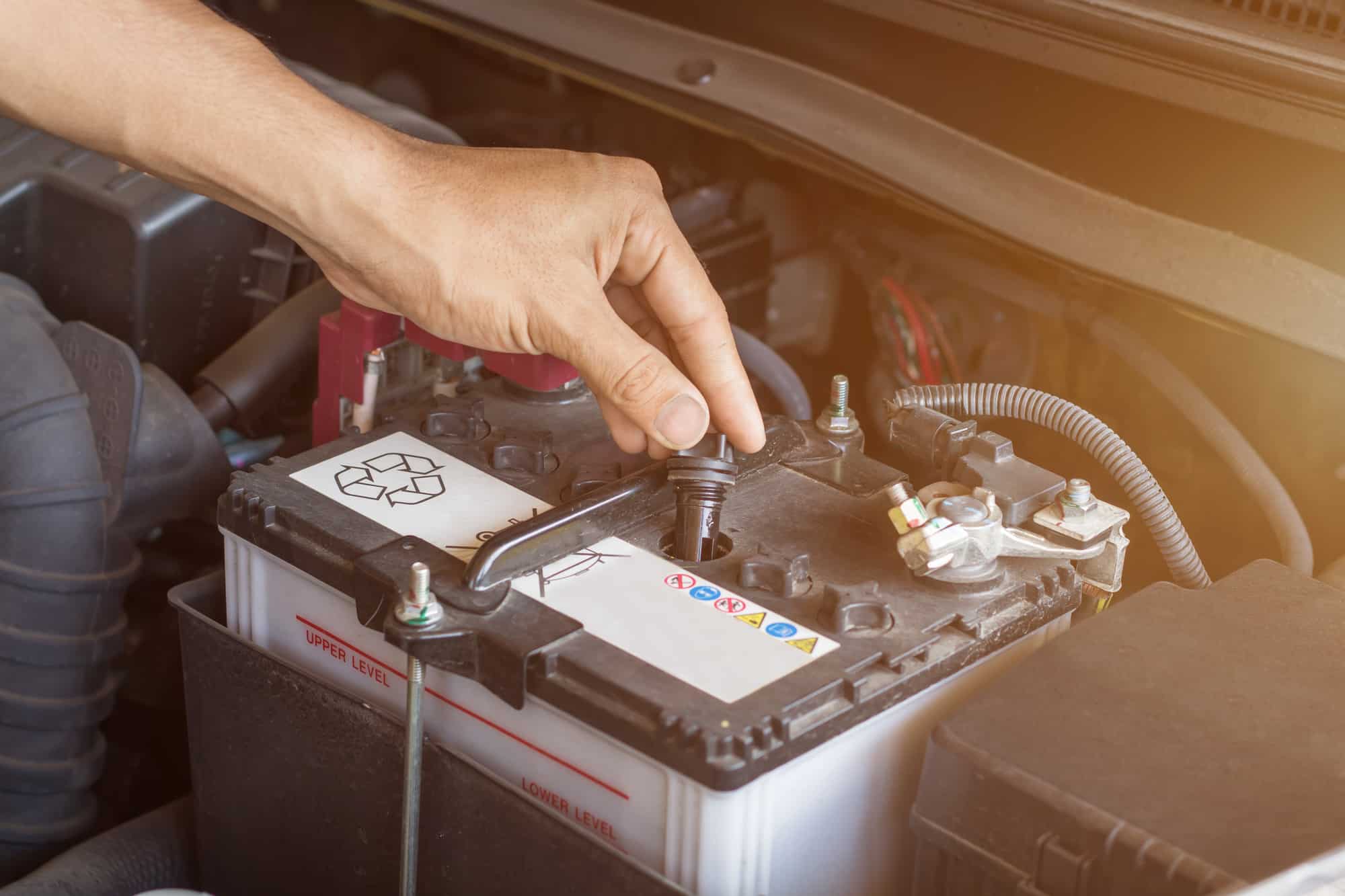 Auto mechanic working check system water and battery