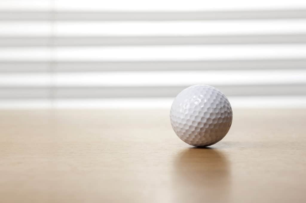 Golf ball on wooden desk