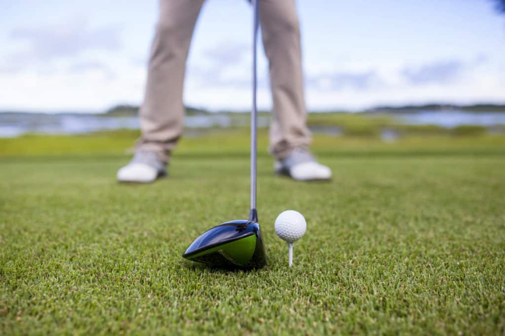 golf club and golf ball on tee