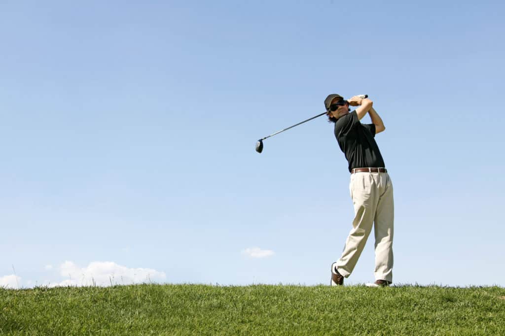 Golfer shooting a golf ball