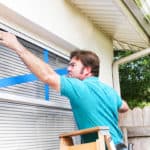 Man Taping His Windows