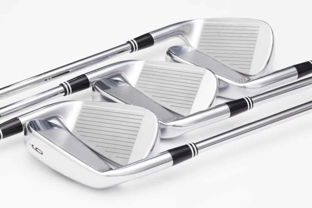 Titanium golf clubs on the white table