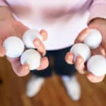 Woman's hands holding several golf balls