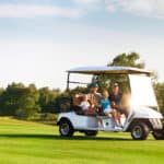 family portrait in a cart at the golf course