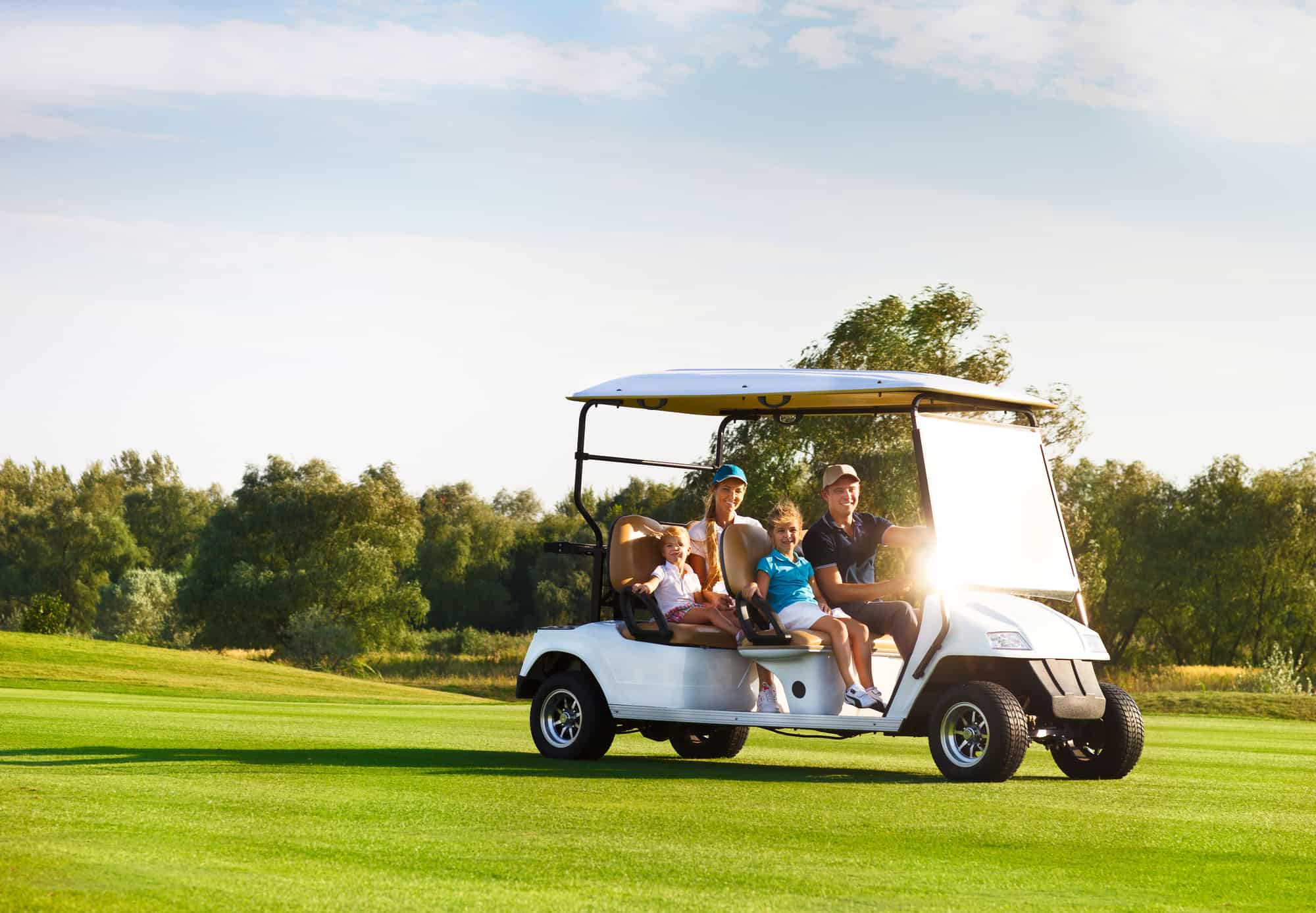 family portrait in a cart at the golf course