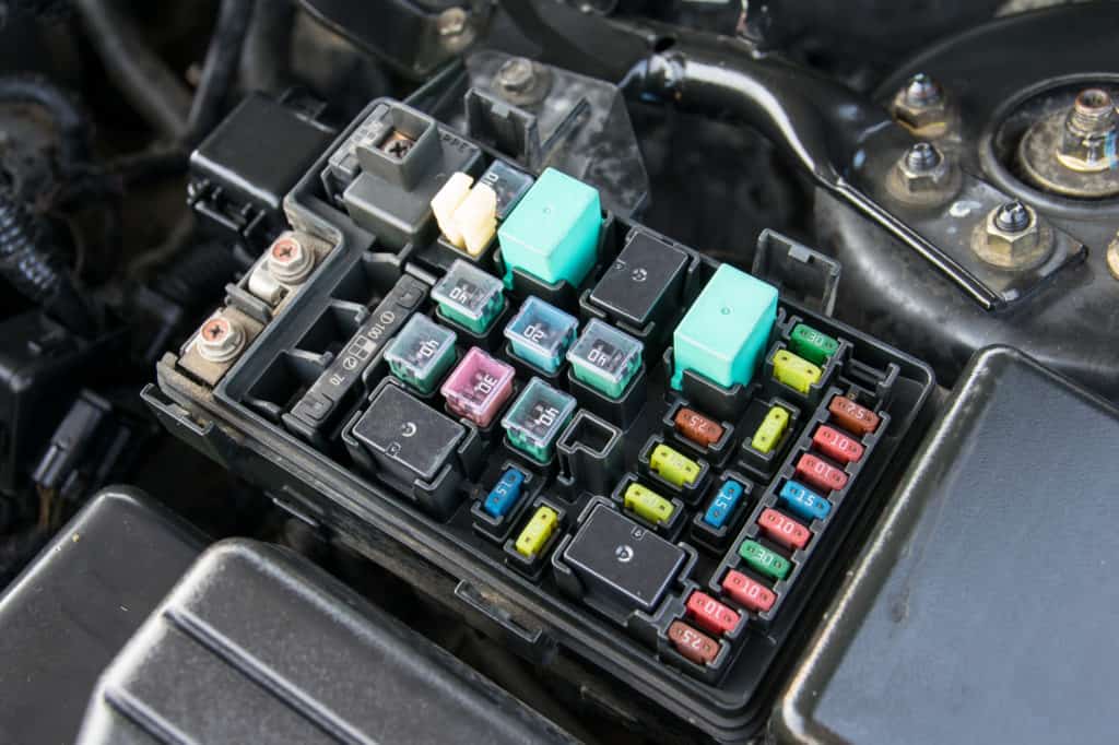 Detail of a car engine bay with fuses