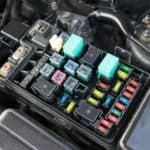 Detail of a car engine bay with fuses