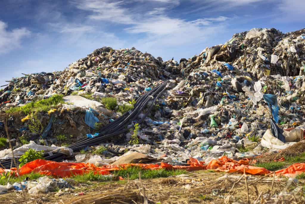 huge landfill site, a special device collects and pumps methane and other gases into storage. Gas through rubber pipes goes to tanks, alternative energy