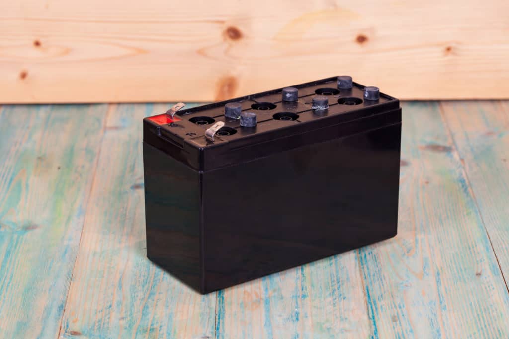 Open Sealed battery on wwood background ,Seletive focus
