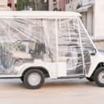 Empty golf car in a cover standing on the street