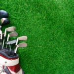 Golf clubs in bag on green grass