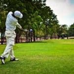 Golfer swinging his golf club