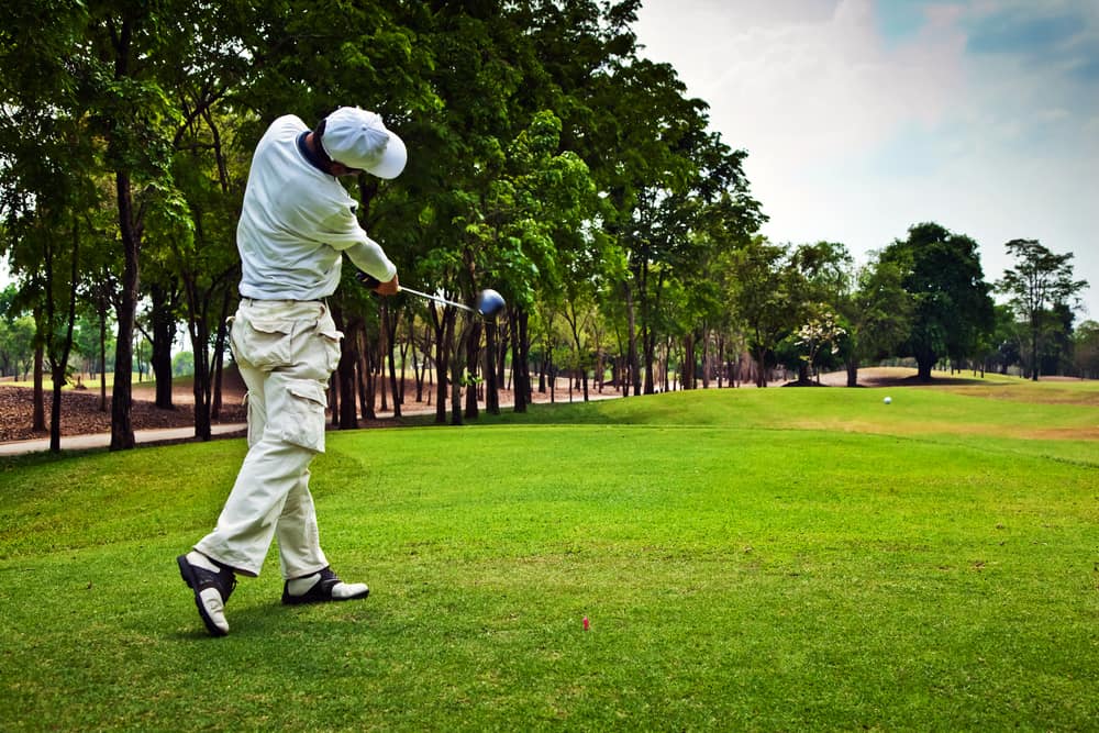 Golfer swinging his golf club