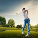 Golfer with golf club taking a shot