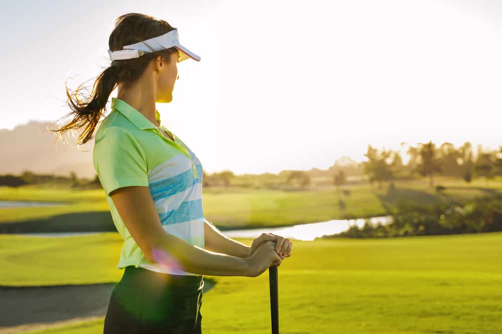 Professional female golfer holding golf club