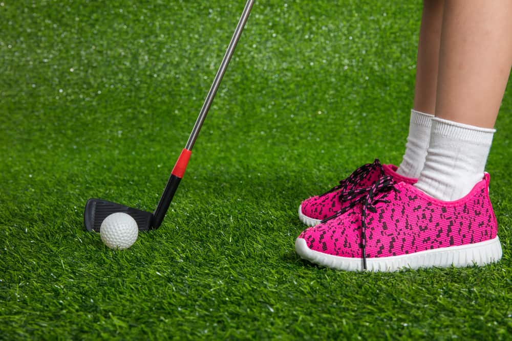 child golfer shoes with putter