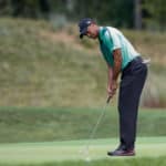 Tiger Woods putts the fourth green